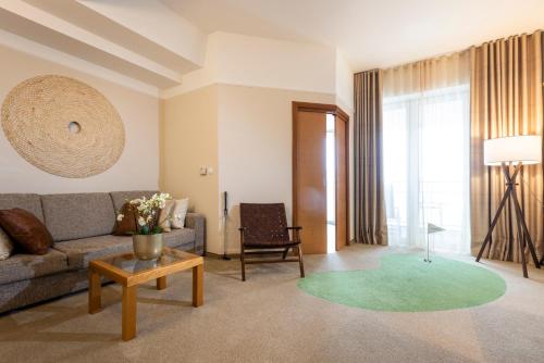 a living room with a couch and a table at Hotel Livada Prestige - Terme 3000 - Sava Hotels & Resorts in Moravske Toplice