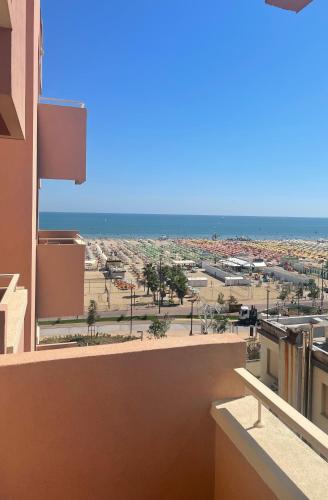 a view of the beach from a balcony of a building at Hotel Bellevue in Rimini