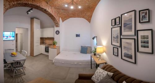 a living room with a bed and a kitchen at Art & Cozy Apartments in Timişoara