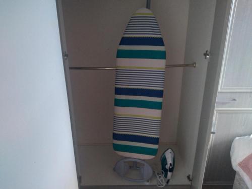 a surfboard is sticking out of a box at Beautiful 2-Bed House in Bolton with free parking in Bolton