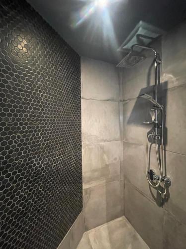 a bathroom with a shower with a shower head at Nanas luxury studio with balcony in Heraklio