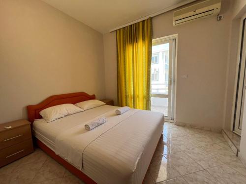 a bedroom with a bed and a large window at Apartments Ela in Ulcinj