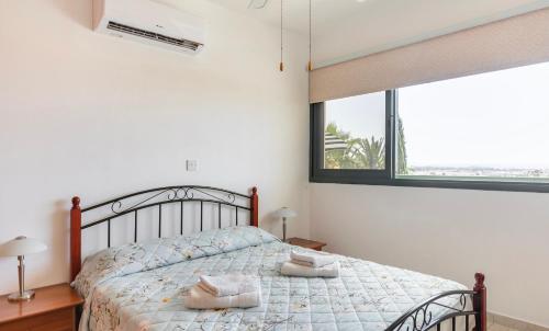 a bedroom with a bed and a large window at Mediterranean dream in Voroklini