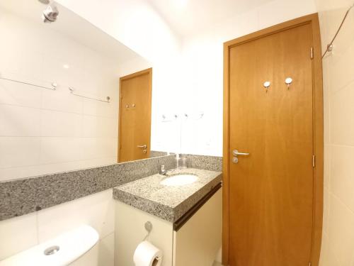 a bathroom with a sink and a mirror at Praia dos Carneiros Flat 206 C in Tamandaré