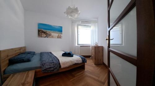 a bedroom with a bed and a window at Apartament 15 min od morza in Gdańsk