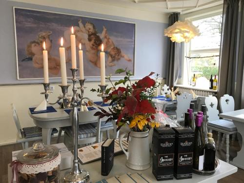 a dining room with a table with candles on it at Klosterhotel Walkenried in Walkenried