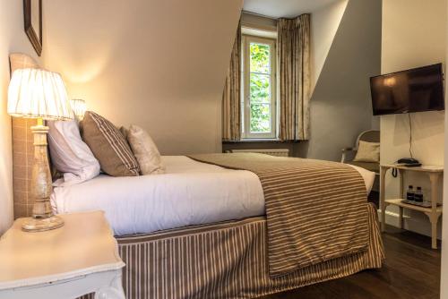 a hotel room with a bed and a window at Pand 17 - Charming Guesthouse in Bruges