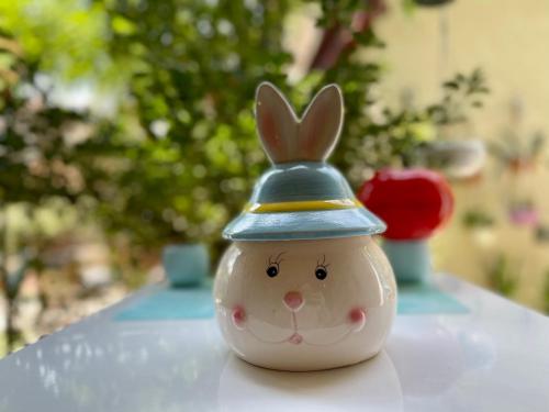 a small toy rabbit wearing a hat on a table at MR Guest House in Tbilisi City