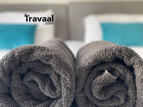 two rolls of towels sitting next to each other at Travaal.©om - 2 Bed Serviced Apartment Farnborough in Farnborough