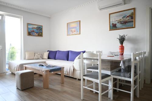 een woonkamer met een bank en een tafel bij Đuričić Apartmani in Budva