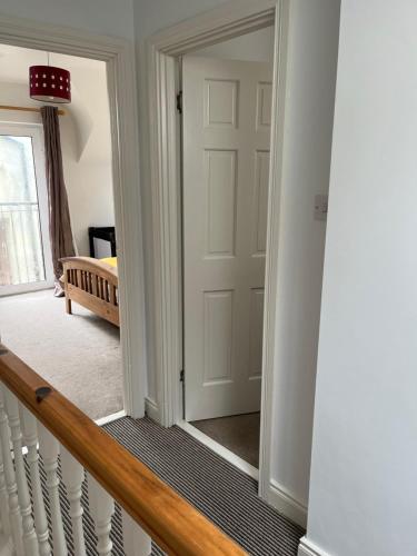 a hallway with a door and a mirror at The Beach House in Lahinch