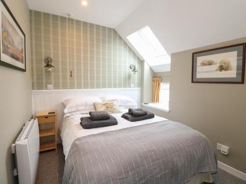 a bedroom with a bed with two pillows on it at Douglas Fir in Newtonmore