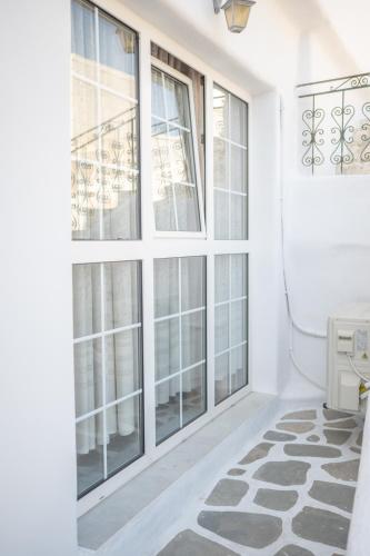 a room with large windows and a rug at Evangelia's Mansion in Naxos Chora