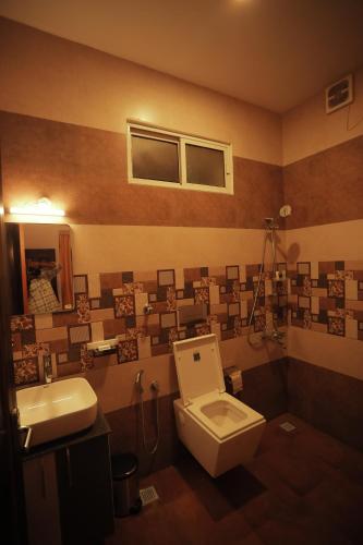 a bathroom with a toilet and a sink at Paadi Holidays Idukki in Idukki