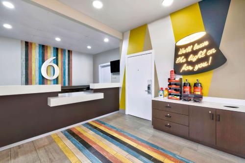 a room with a kitchen with a colorful wall at Motel 6-Plano, TX - Plano Northeast in Plano