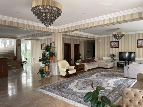 a large living room with a chandelier at Hotel City Samarkand in Samarkand