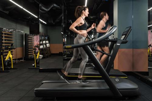 two women walking on a treadmill in a gym at QT Perth in Perth