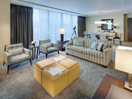 a living room with couches and chairs and a table at Fairmont Pittsburgh in Pittsburgh