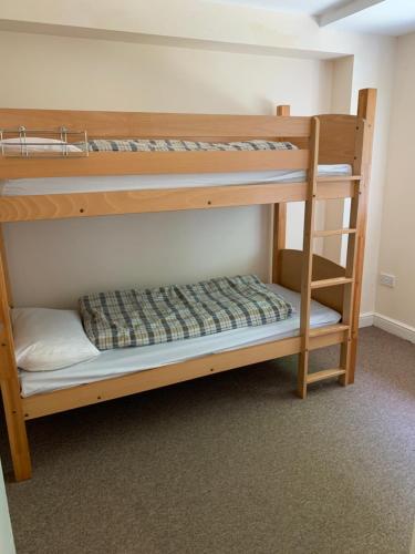 a couple of bunk beds in a room at Stonehenge Hostel in Amesbury