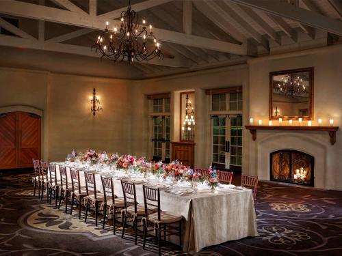 a long table in a room with chairs and a chandelier at Fairmont Sonoma Mission Inn & Spa in Sonoma