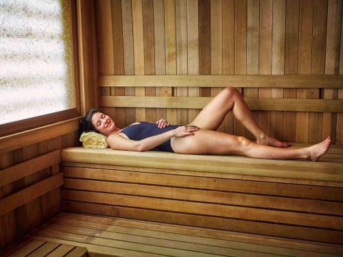 a woman is laying in a sauna at Fairmont Sonoma Mission Inn & Spa in Sonoma