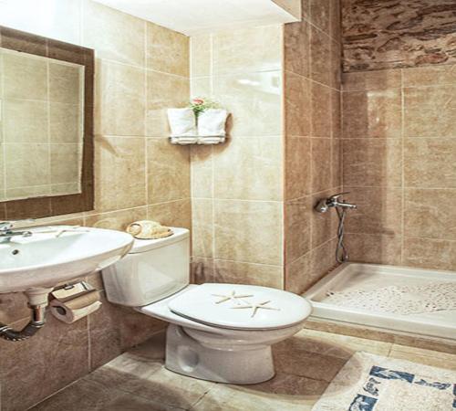 a bathroom with a toilet and a sink and a tub at Boutique Hotel Tsopela in Skiathos Town