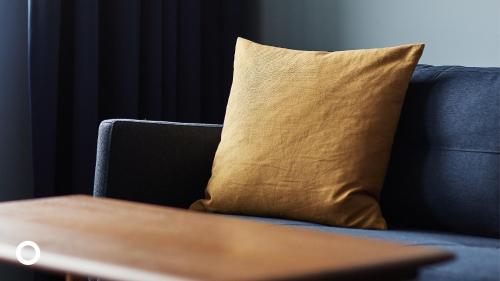 a yellow pillow sitting on a blue couch at Grandi by Center Hotels in Reykjavík