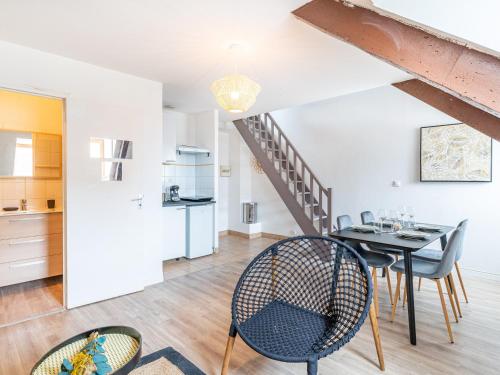 a kitchen and dining room with a table and chairs at Le Guindy in Tréguier