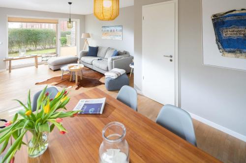 a living room with a table and a couch at Mühlenloft in Norderney