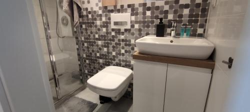 a bathroom with a sink and a toilet and a shower at Labo Apartment Bagno Palace of Culture View in Warsaw
