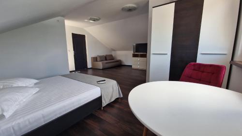 a bedroom with a bed and a table and a chair at Casa Carpov Sulina in Sulina