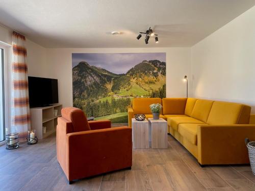 a living room with a yellow couch and a television at Ferienwohnungen Alpentraum - Oberstdorfer Berglodge in Oberstdorf