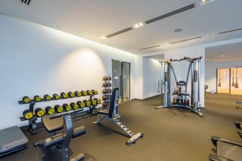 a gym with several treadmills and weights at Eaton Residence KLCC in Kuala Lumpur
