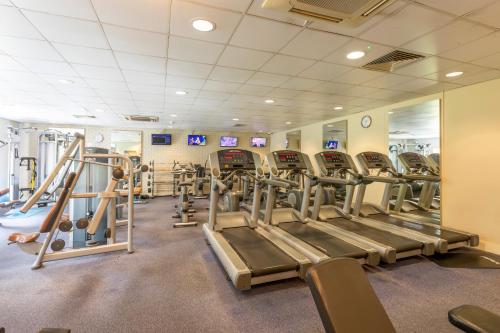 a gym with rows of treadmills and weights at Holiday Inn Guildford by IHG in Guildford