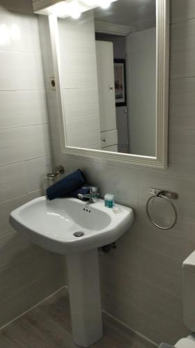 a bathroom with a white sink and a mirror at Sansoain Jaca in Jaca