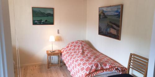 a bedroom with a bed and a table with a lamp at Apartment in Selatrað - Free parking in Selatrað