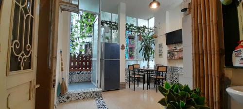 a hallway with a dining room and a table with chairs at Green Homestay in Hanoi
