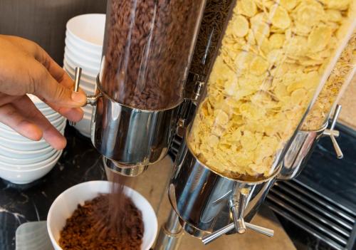 a person is pouring chocolate into a mixer at Holiday Inn Express Jakarta International Expo by IHG in Jakarta