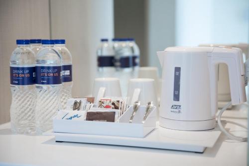 a coffee maker and bottles of water on a counter at Holiday Inn Express Jakarta International Expo by IHG in Jakarta