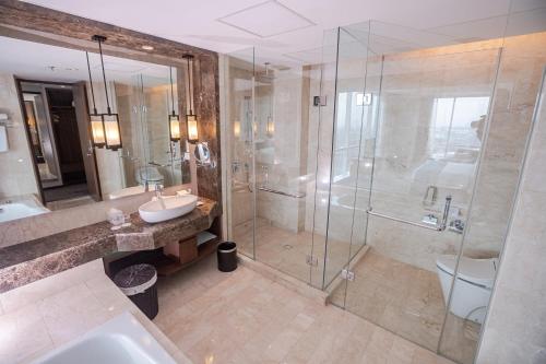 a bathroom with a shower and a sink and a toilet at Crowne Plaza Bandung by IHG in Bandung