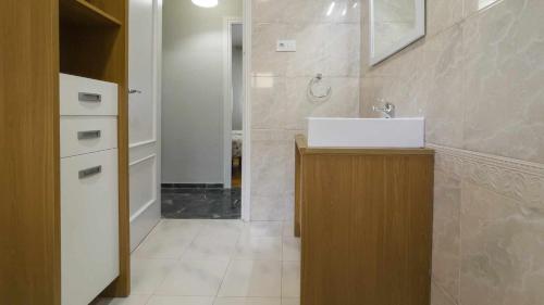 a bathroom with a white sink and a shower at La casa de la tinaja piscina y chimenea by Toledo AP in Villamiel de Toledo