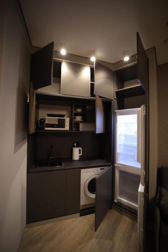 a small kitchen with a sink and a washing machine at AVENUE RESIDENCE by AY North Avenue in Yerevan