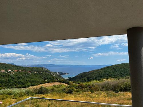 a view of the ocean from a house window at Merlo APP in Labin
