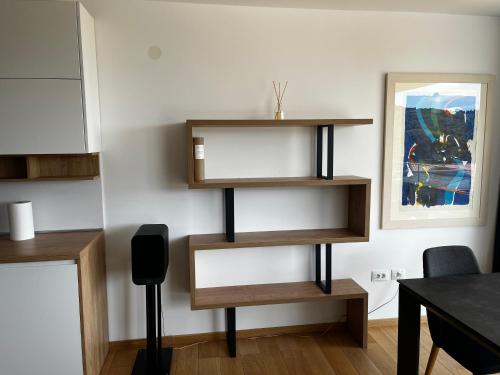 a living room with wooden shelves on the wall at Merlo APP in Labin