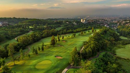 an aerial view of a golf course with trees at InterContinental Bandung Dago Pakar by IHG in Bandung