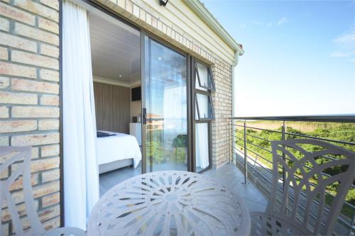 a balcony with a view of a bedroom at King Guest Lodge in Port Elizabeth