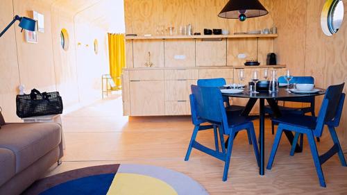 a kitchen with a table, chairs and a refrigerator at The Unbound in Amsterdam