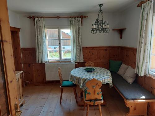 a dining room with a table and a window at Haus Erni in Bad Aussee