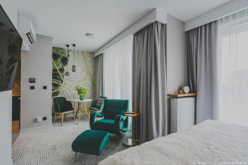 a hotel room with a bed and a table and chairs at Royal Tulip Warsaw Centre in Warsaw