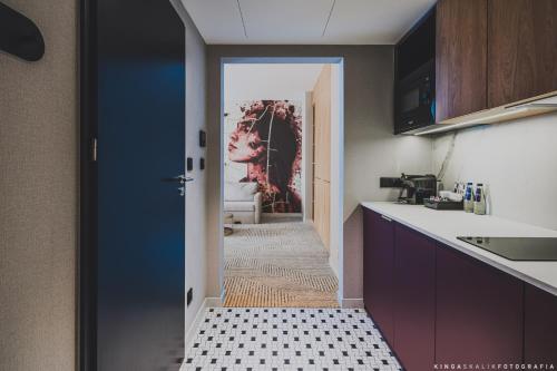 a kitchen with a door leading to a hallway at Royal Tulip Warsaw Centre in Warsaw
